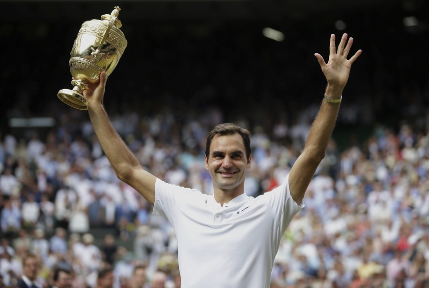 Switzerland&#039;s Roger Federer celebrates with the trophy after beating Croatia&#039;s Marin Cilic in the Men&#039;s Singles final match on day thirteen at the Wimbledon Tennis Championships in Lond ...