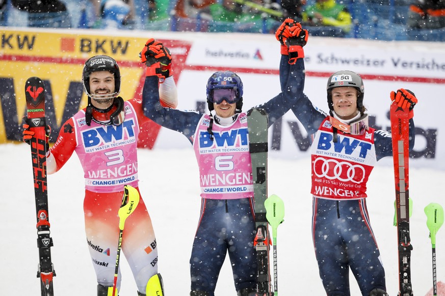 epa10406869 Second placed Loic Meillard of Switzerland, winner Henrik Kristoffersen of Norway, and Third placed Lucas Braathen of Norway, from left, celebrate in the finish area after the second run o ...