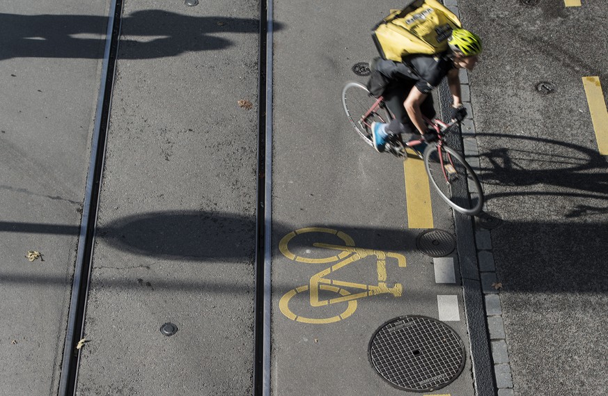 THEMENBILD ZUM GESAMTARBEITSVERTRAG GAV FUER VELOKURIERE --- Ein Velokurier faehr an einer Radweg Markierung an der Zuercher Josefstrasse vorbei, aufgenommen am 16. Oktober 2013 in Zuerich. (KEYSTONE/ ...