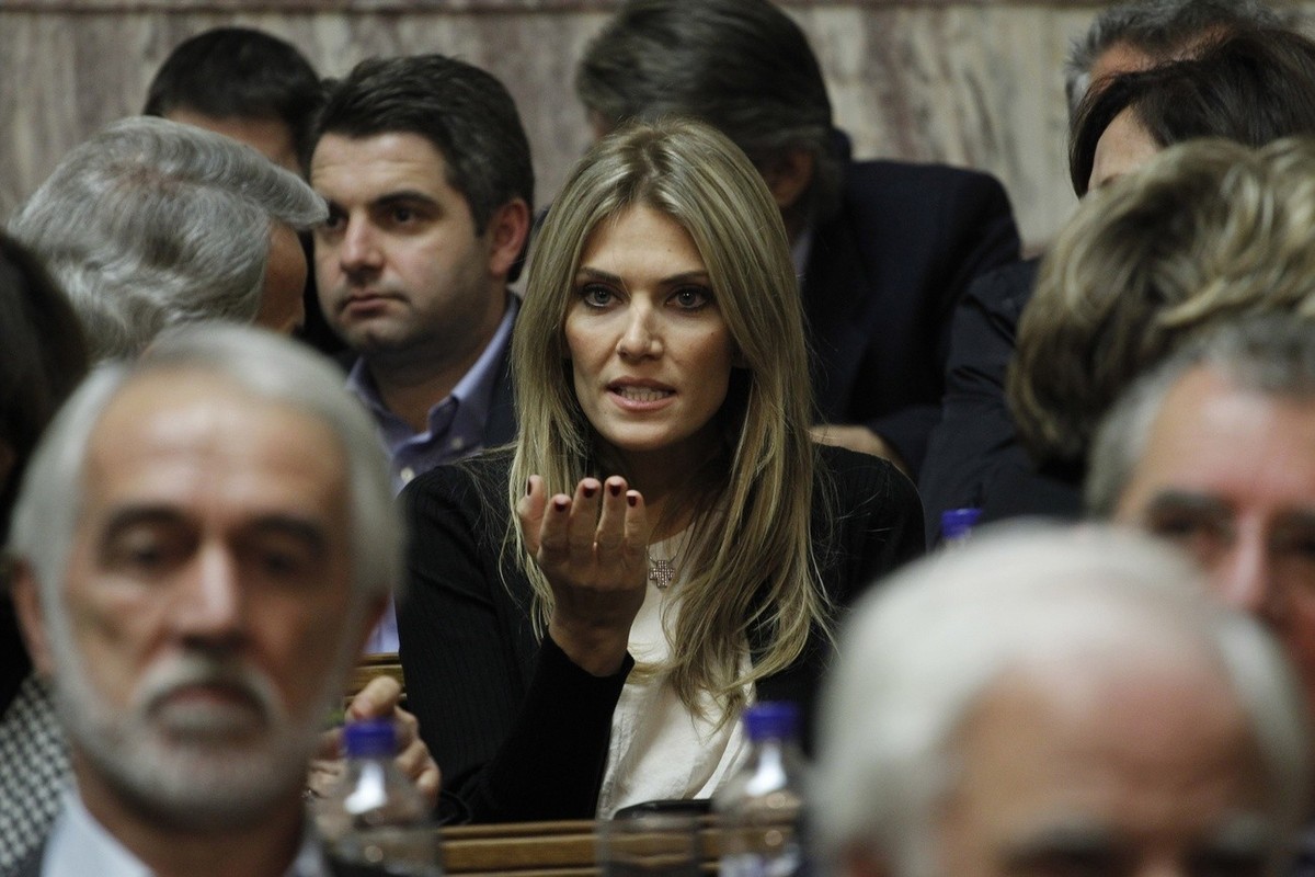 Socialist lawmaker Eva Kaili, center, chats prior the speech of Greek prime minister George Papandreou to his Socialist lawmakers members of parliament, in Athens, Thursday , Nov. 3, 2011 Papandreou h ...