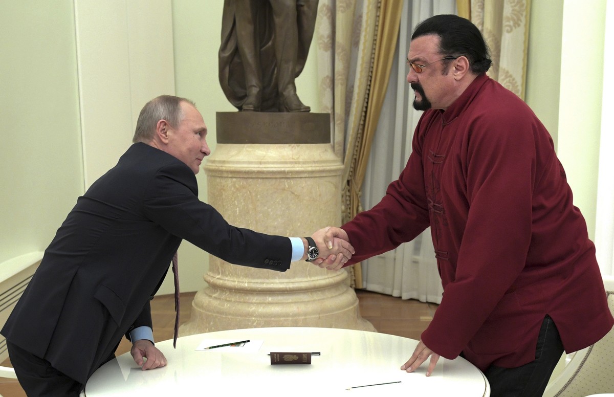 FILE - Russian President Vladimir Putin shakes hands with U.S. actor Steven Seagal in the Kremlin in Moscow, during a ceremony to award a Russian passport, Nov. 25, 2016. Russian President Vladimir Pu ...