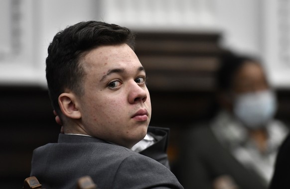 FILE - Kyle Rittenhouse looks back as attorneys argue about the charges that will be presented to the jury during proceedings at the Kenosha County Courthouse in Kenosha, Wis., in this Nov. 12, 2021 f ...