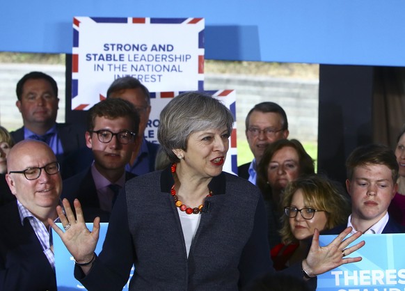 epa05940991 British Prime Minister Theresa May (C) delivers a speech on the campaign trail at the Hungerford Community and Social Club in Brislington, Bristol, Britain, 02 May 2017. Voters go to the p ...
