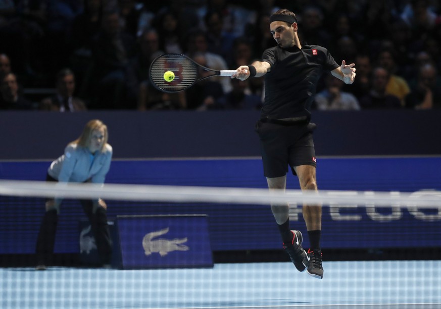 Switzerland&#039;s Roger Federer plays a return to Italy&#039;s Matteo Berrettini during their ATP World Tour Finals singles tennis match at the O2 Arena in London, Tuesday, Nov. 12, 2019. (AP Photo/A ...