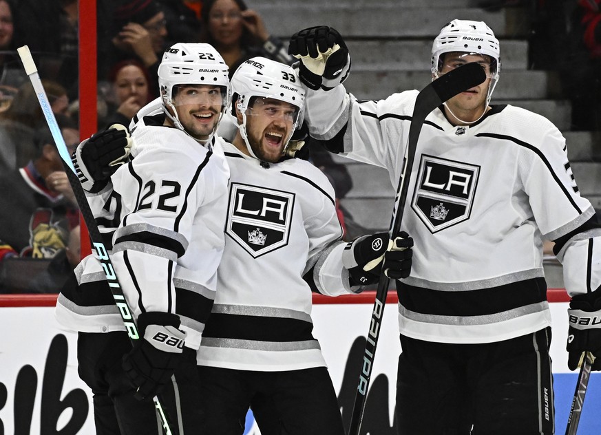 Los Angeles Kings right wing Viktor Arvidsson celebrates scoring his second goal of the game against the Ottawa Senators with teammates Kevin Fiala (22) and Matt Roy during the first period of an NHL  ...