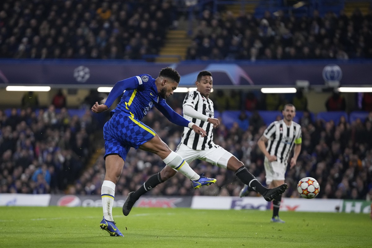 Chelsea's Reece James attempts a shot at goal in front of Juventus' Alex Sandro during the Champions League group H soccer match between Chelsea and Juventus at Stamford Bridge stadium in Lo ...