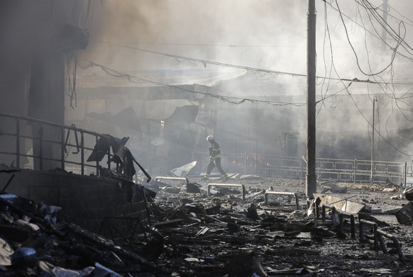 epaselect epa12989705 A Ukrainian rescuer works at the site of a Russian strike on a shopping center in Kyiv, Ukraine, 24 May 2026, amid the Russian invasion. More than 600 drones and 90 missiles stru ...