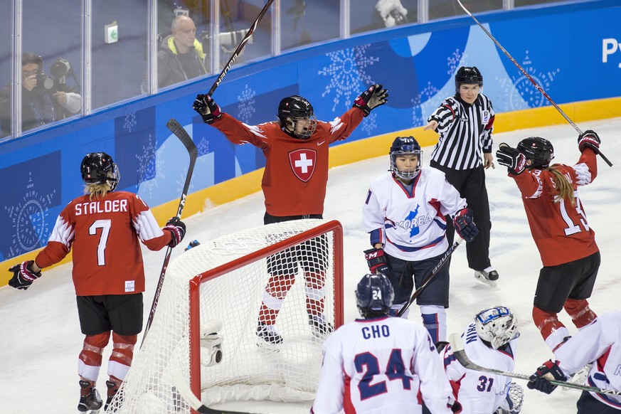 Switzerland&#039;s Lara Stalder, Alina Muller and Sara Benz, from left, celebrate during the women ice hockey preliminary round match between Switzerland and unified Korean team in the Kwandong Hockey ...