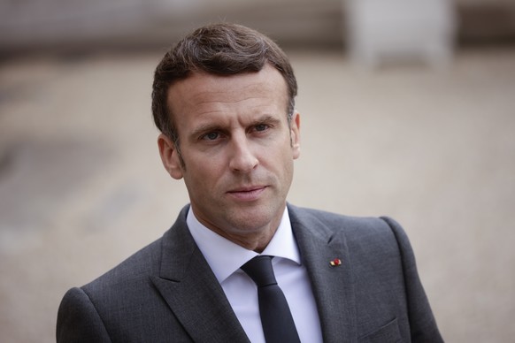 epa09193659 French President Emmanuel Macron speaks to the media as he welcomes Argentinian President Alberto Fernandez (not pictured) at the Elysee Palace in Paris, France, 12 May 2021. EPA/YOAN VALA ...