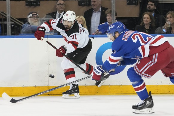 New Jersey Devils defenseman Jonas Siegenthaler (71) moves the puck around New York Rangers center Barclay Goodrow (21) during the first period of an NHL hockey game, Saturday, April 29, 2023, at Madi ...