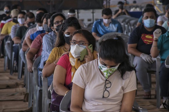 Indian youth wait to get vaccinated against the coronavirus at Radha Soami Satsang Ground in New Delhi, India, Wednesday, May 5, 2021. (AP Photo/Ishant Chauhan)