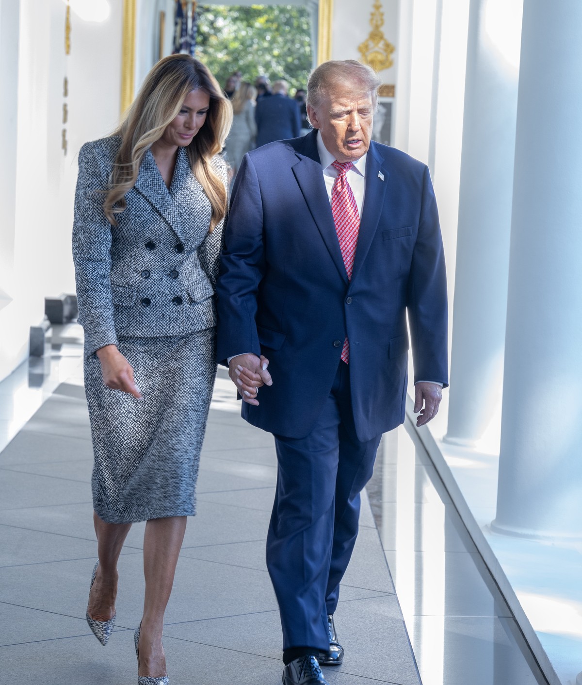 epa13315785 United States President Donald J Trump and first lady Melania Trump hold hands as they walk on the Colonnade prior to signing an executive order to establish the Women's Health Divisi ...