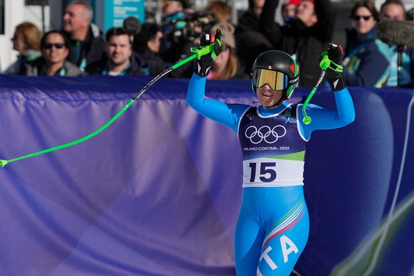 Italy's Sofia Goggia celebrates at the finish area of an alpine ski women's downhill race, at the 2026 Winter Olympics, in Cortina d'Ampezzo, Italy, Sunday, Feb. 8, 2026. (AP Photo/Andy ...