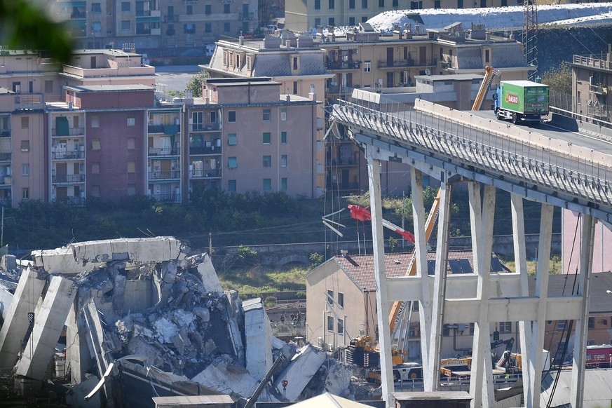 A truck is blocked at the end of the collapsed Morandi highway bridge in Genoa, northern Italy, Wednesday, Aug. 15, 2018. A bridge on a main highway linking Italy with France collapsed in the Italian  ...