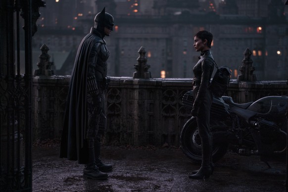 This image released by Warner Bros. Pictures shows Robert Pattinson, left, and Zoe Kravitz in a scene from &quot;The Batman.&quot; (Jonathan Olley/Warner Bros. Pictures via AP)