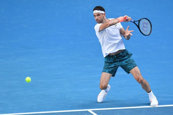 epa09011260 Grigor Dimitrov of Bulgaria in action during his fourth Round Men&#039;s singles match against Dominic Thiem of Austria at the Australian Open grand slam tennis tournament at Melbourne Par ...