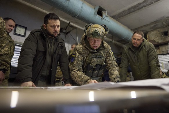 epa11003556 A handout photo made available by the presidential press service shows Ukrainian President Volodymyr Zelensky (L) taking part in a meeting with commanders at the headquarters of the Defens ...
