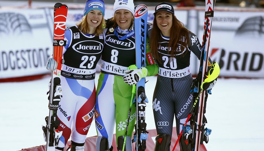 From left, Switzerland's Michelle Gisin, Slovenia's Ilka Stuhec and Italy's Sofia Goggia pose after completing an alpine ski, women's World Cup combined, in Val d'Isere, France, Friday, Dec. 16, 2016. ...