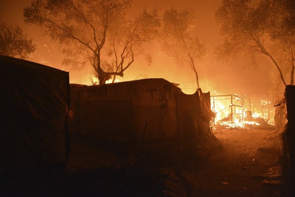 Fire burns makeshift tents at the Moria refugee camp on the northeastern Aegean island of Lesbos, Greece, on Wednesday, Sept. 9, 2020. Fire Service officials say a large refugee camp on the Greek isla ...