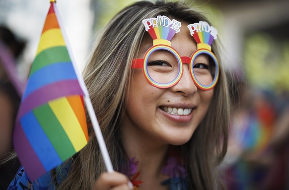 epa10020235 A woman attends the Zurich Pride parade under the slogan &#039;trans D living diversity&#039; for the rights of the LGBTIQ community, in Zurich, Switzerland, 18 June 2022. EPA/MICHAEL BUHO ...