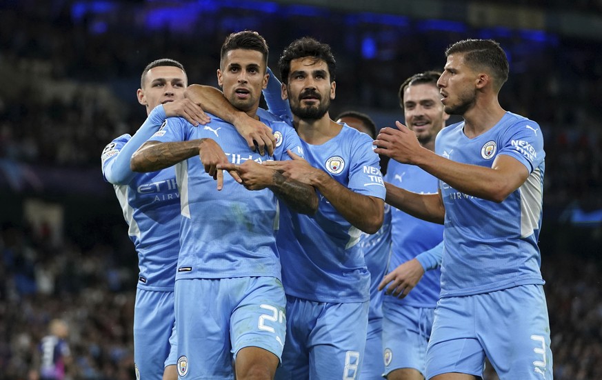 Manchester City&#039;s Joao Cancelo, second left, celebrates with Phil Foden, left, Ilkay Gundogan, center, and Ruben Dias, right, after scoring during the Champions League Group A soccer match betwee ...