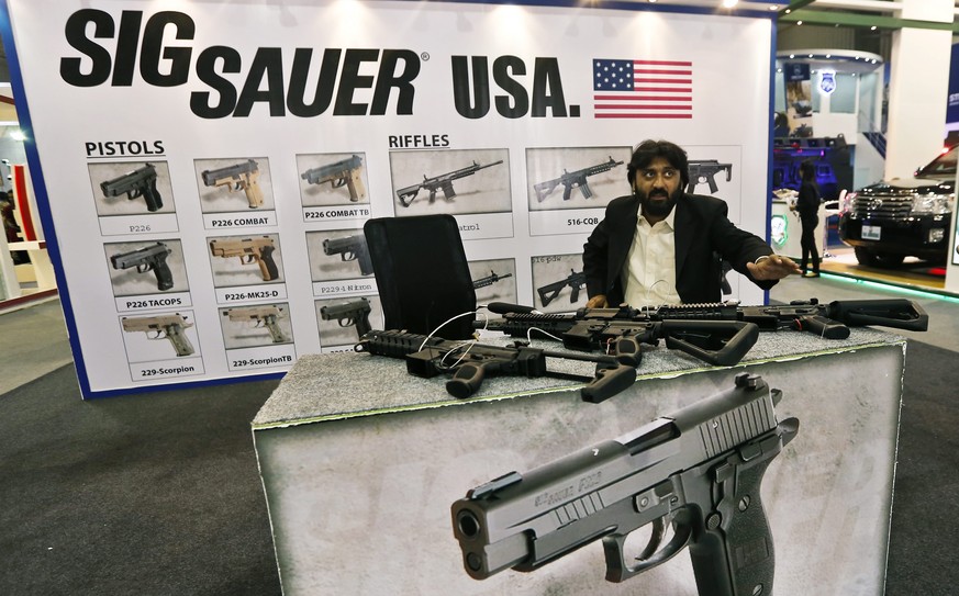epa04511897 Weapons from US manufacturer SIG Sauer on display at the International Defense Exhibition And Seminar (IDEAS) 2014, Karachi, Pakistan, 02 December 2014. As one of the most volatile regions ...
