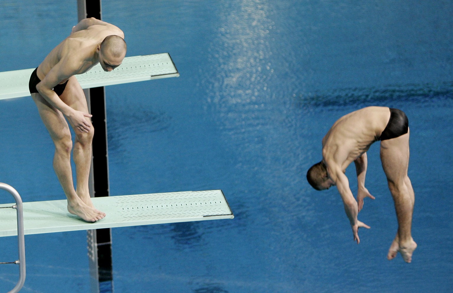 Russian diver Aleksandr Dobroskok left, fails to dive as partner Gleb Galperin completes their routine during the final of the men&#039;s 3-meter synchro springboard event at the World Swimming Champi ...