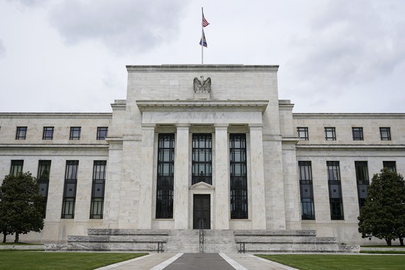 FILE - In this May 4, 2021, file photo is the Federal Reserve building in Washington.The Federal Reserve says it will start selling off the holdings of one of its emergency lending programs created la ...