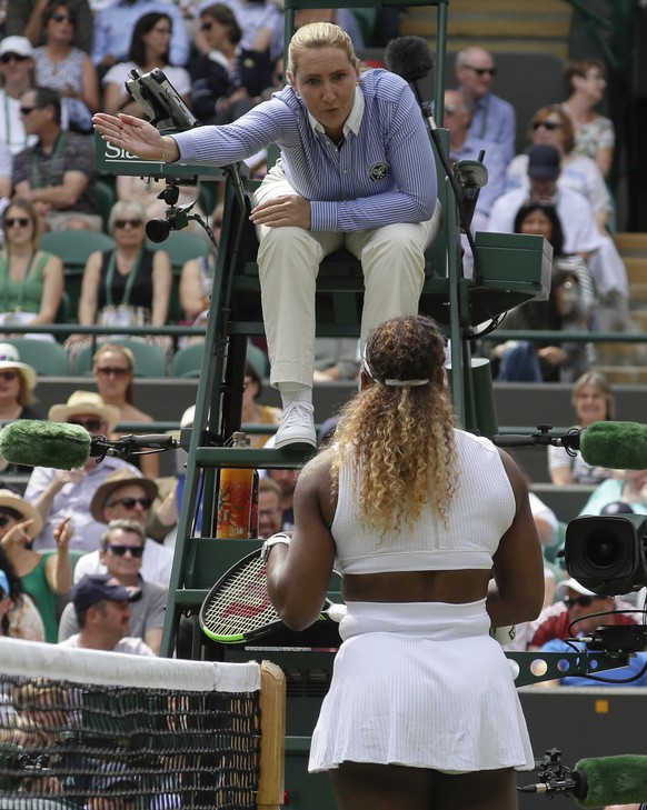 United States&#039; Serena Williams listens to umpire Aurelie Tourte in a women&#039;s singles match against Spain&#039;s Carla Suarez Navarro during day seven of the Wimbledon Tennis Championships in ...