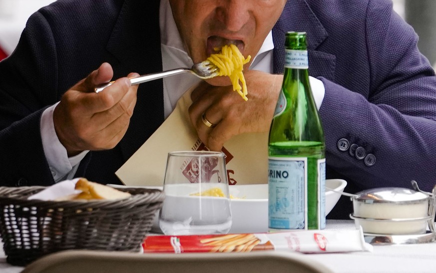 A man eats pasta in a restaurant in Milan, northern Italy, Thursday, June 8, 2023. Italians are calling for a pasta protest as food prices squeeze Europe. Grocery prices have risen more sharply in Eur ...