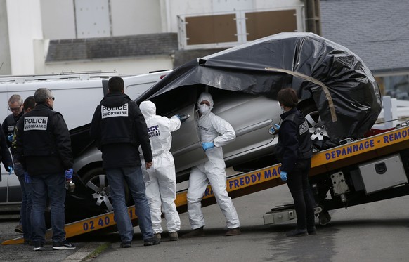 French investigating police prepare to remove the abandoned automobile of Sebastien Troadec in a parking lot in Saint Nazaire, France, March 2, 2017. The family Troadec, the couple and their two child ...