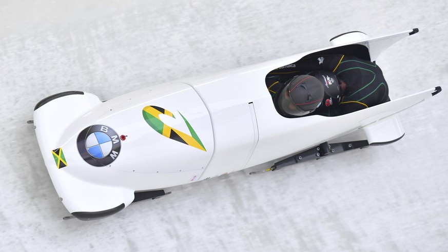 Jazmine Fenlator-Victorian and Carrie Russell of Jamaica speed down the track during their first run of the women&#039;s bobsled World Cup race in Innsbruck, Saturday, Dec. 16, 2017. (AP Photo/Kerstin ...