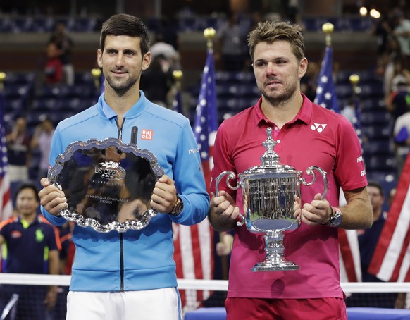Stan Wawrinka, of Switzerland, right, and Novak Djokovic, of Serbia, pose for a photo after Wawrinka beat Djokovic to win the men&#039;s singles final of the U.S. Open tennis tournament, Sunday, Sept. ...