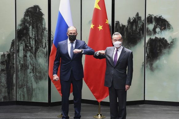 In this photo released by Xinhua News Agency, Chinese Foreign Minister Wang Yi poses for photos with Russian Foreign Minister Sergei Lavrov in Tunxi, eastern China&#039;s Anhui Province, Wednesday, Ma ...