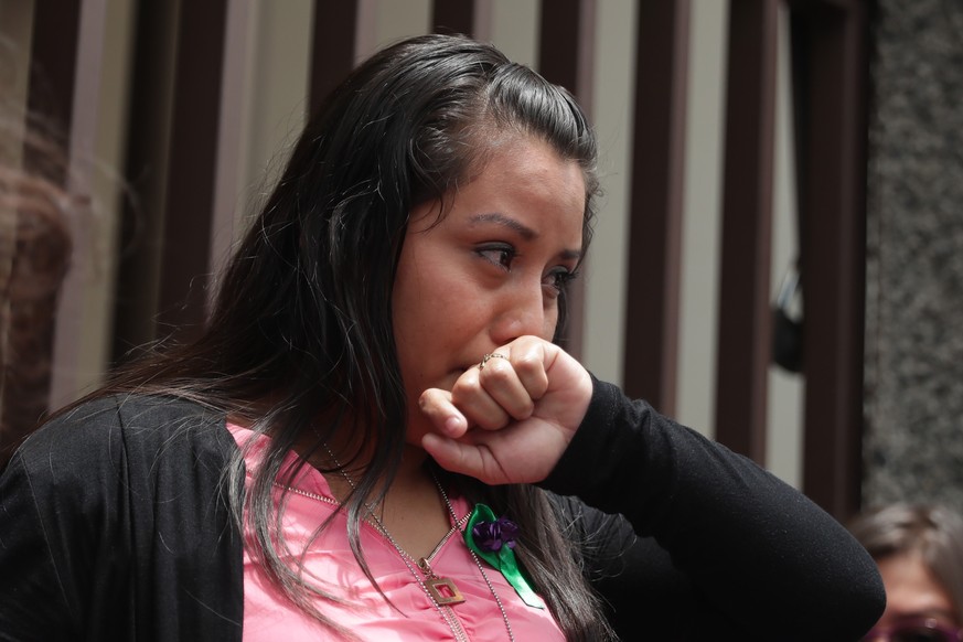 epa07781409 Evelyn Hernandez (C), 21, reacts after court absolved her from an alleged abortion crime, in Ciudad Delgado, El Salvador, 19 August 2019. Hernandez was absolved for having allegedly had an ...