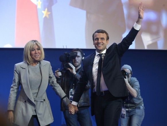 French centrist presidential candidate Emmanuel Macron and his wife Brigitte arrives to address his supporters at his election day headquarters in Paris , Sunday April 23, 2017. Macron and far-right p ...