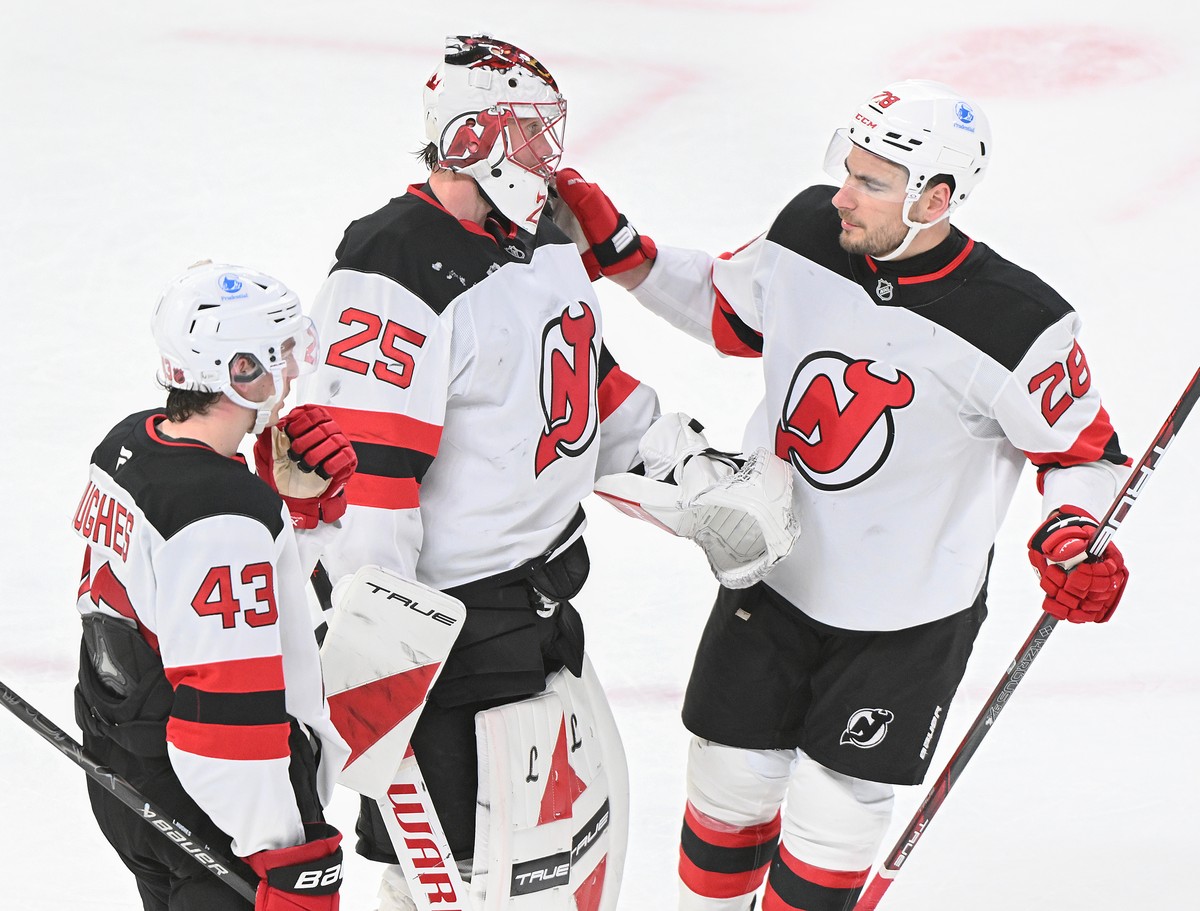 New Jersey Devils goaltender Jacob Markstrom (25), Timo Meier (28) and Luke Hughes (43) celebrate their win over the Montreal Canadiens in an NHL hockey game in Montreal, Sunday, April 5, 2026. (Graha ...