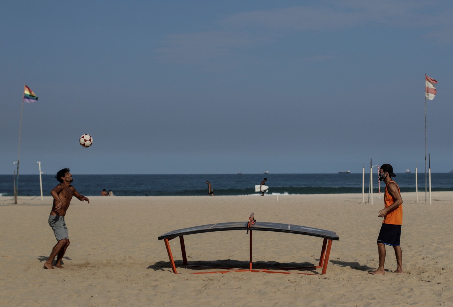 epa08552748 Two men are seen while practicing sports on the Copacabana beach in Rio de Janeiro, Brazil, 17 July 2020. Rio has the first day of authorized collective sports during the COVID-19 pandemic ...