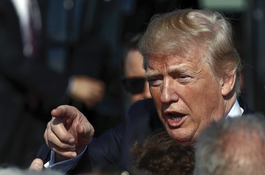 FILE - In this Friday Dec. 22, 2017, file photo President Donald Trump greets people on the tarmac as he arrives at Palm Beach International Airport, in West Palm Beach, Fla. Trump wants to countersue ...