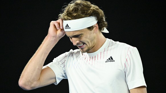 epa09690828 Alexander Zverev of Germany reacts during his first Round Men&#039;s singles match against Daniel Altmaier of Germany on Day 1 of the Australian Open tennis tournament, at Melbourne Park,  ...