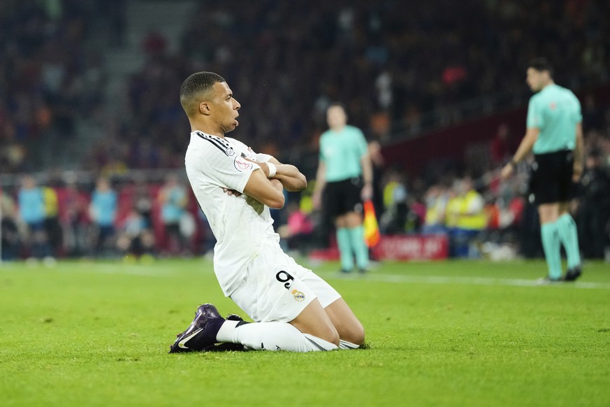 Real Madrid&#039;s Kylian Mbappe celebrates after scoring his side&#039;s opening goal during the Spanish Copa del Rey final soccer match between Barcelona and Real Madrid at Estadio de La Cartuja sta ...