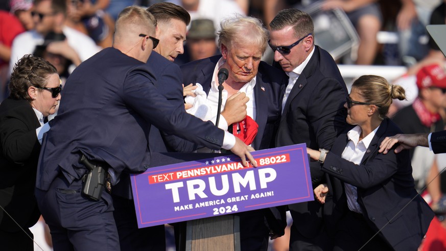 FILE - Republican presidential candidate former President Donald Trump is helped off the stage at a campaign event in Butler, Pa., July 13, 2024. (AP Photo/Gene J. Puskar, File)
Donald Trump