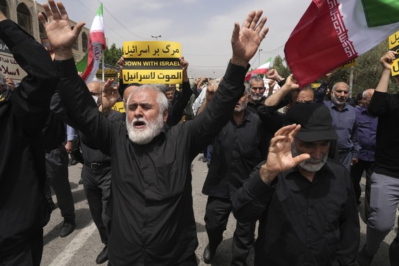 Worshippers chant slogans during a protest against Sweden after the Nordic nation allowed an Iraqi man to insult the Muslim holy book, the Quran, after their Friday prayers in Tehran, Iran, Friday, Ju ...