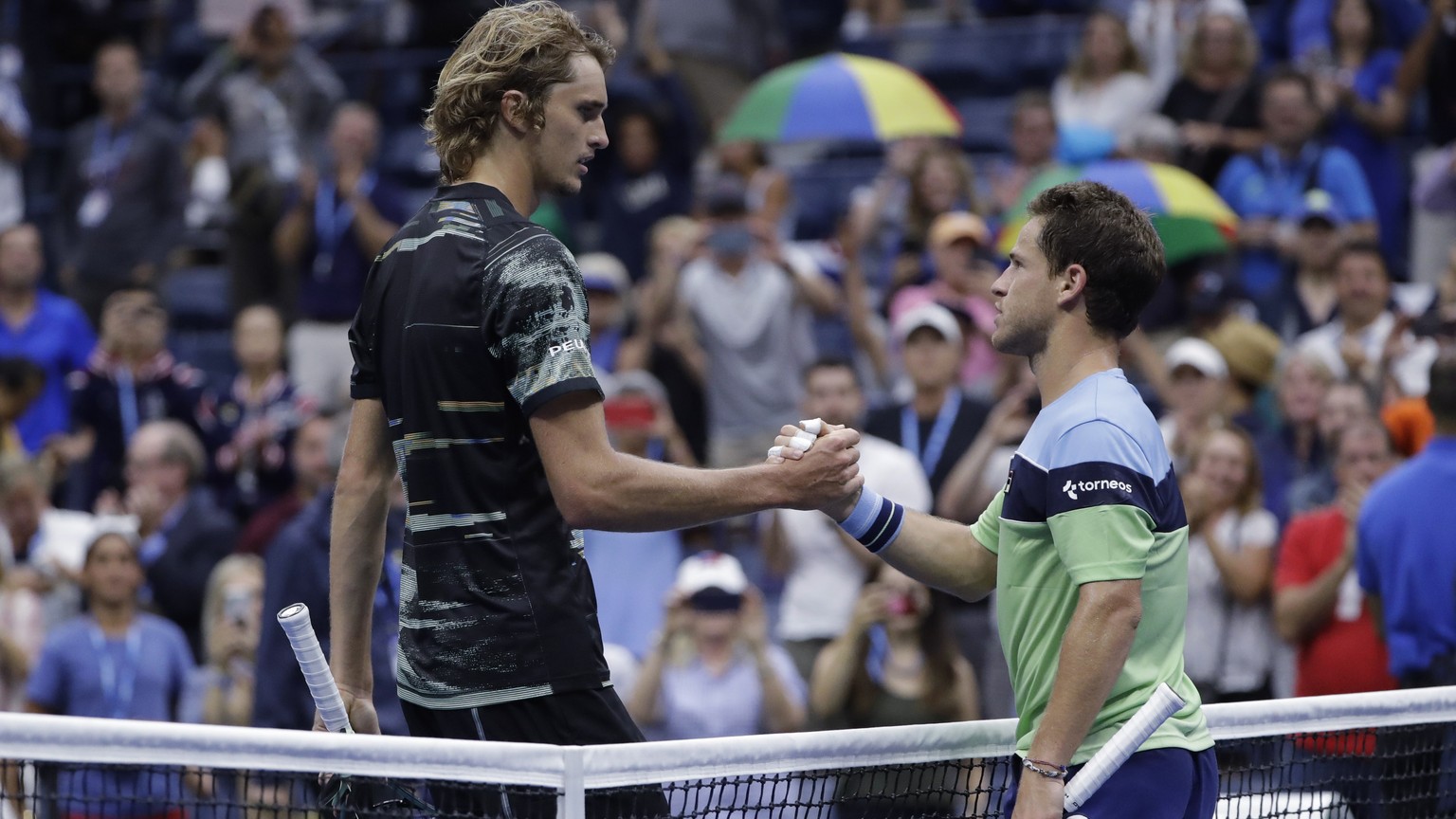 Diego Schwartzman, of Argentina, right, shakes hands after defeating Alexander Zverev, of Germany, during the fourth round of the US Open tennis championships Monday, Sept. 2, 2019, in New York. (AP P ...