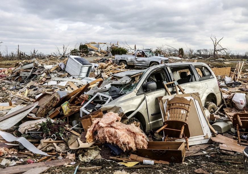 Damaged vehicles and personal property are strewn over a wide area along Kentucky 81, Saturday, Dec. 11, 2021, in Bremen, Ky, after a devastating tornado swept through the area on Friday night. (Greg  ...