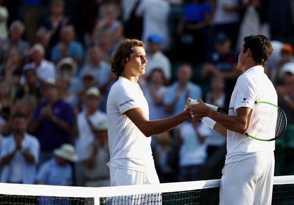 epa06079888 Milos Raonic (R) of Canada celebrates winning against Alexander Zverev (L) of Germany during their fourth round match for the Wimbledon Championships at the All England Lawn Tennis Club, i ...