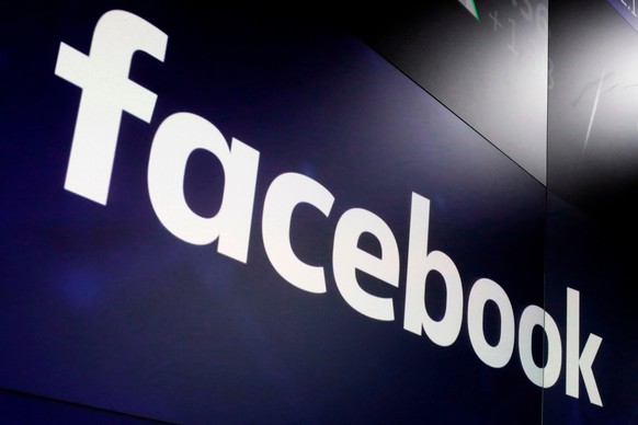 FILE- In this March 29, 2018, file photo, the logo for Facebook appears on screens at the Nasdaq MarketSite in New York&#039;s Times Square. A German federal court has faulted aspects of FacebookÄôs  ...