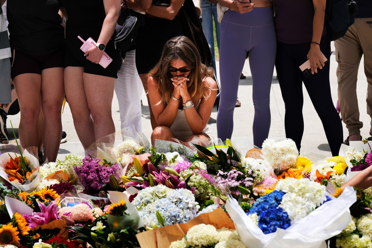 A woman kneels and prays at a flower memorial to shooting victims outside the Bondi Pavilion at Sydney's Bondi Beach, Monday, Dec. 15, 2025, a day after a shooting. (AP Photo/Mark Baker)
APTOPIX  ...