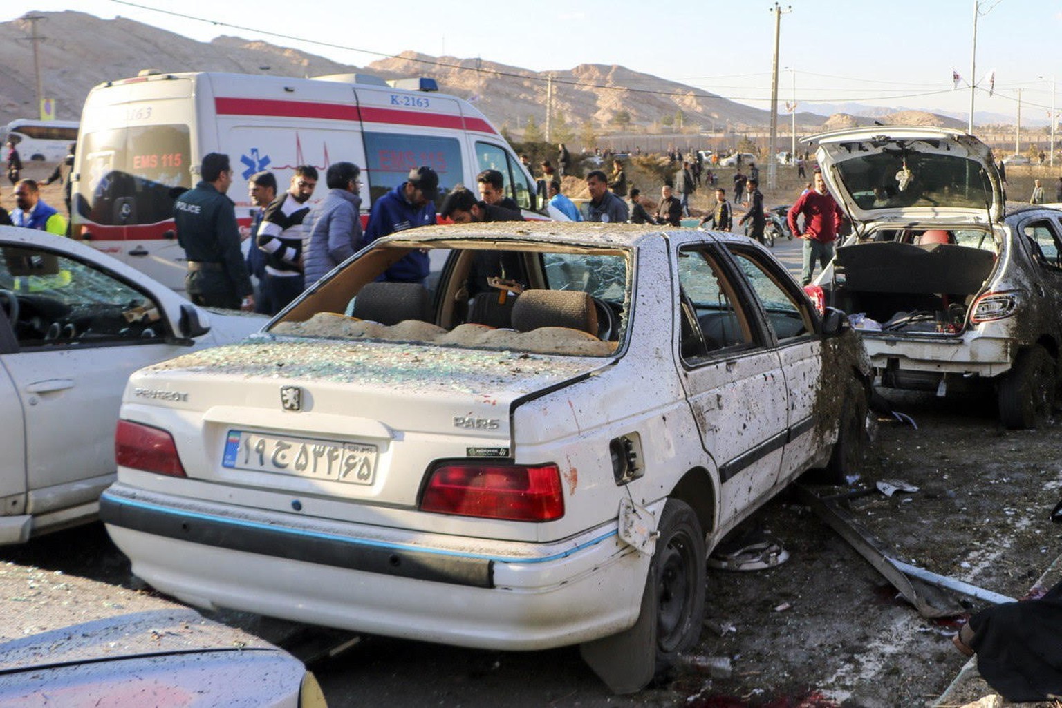 epa11055381 Damaged cars are seen as people try to help victims after an explosion next to the tomb of Iran&#039;s Revolutionary Guards chief of foreign operations in the Saheb al-Zaman mosque in the  ...