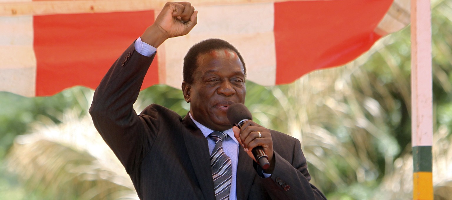 FILE - In this Wednesday Feb, 10, 2016 file photo, Zimbabwean vice President Emmerson Mnangagwa greets party supporters at the ZANU-PF headquarters in Harare. (AP Photo/Tsvangirayi Mukwazhi, File)